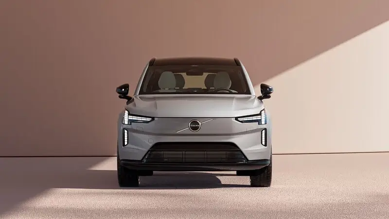 Predný pohľad na Volvo EX90 v sivej farbe s pokročilými LED svetlometmi novej generácie a uzavretou maskou elektromobilu